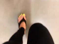 Mature feet walking in platform flip flops
